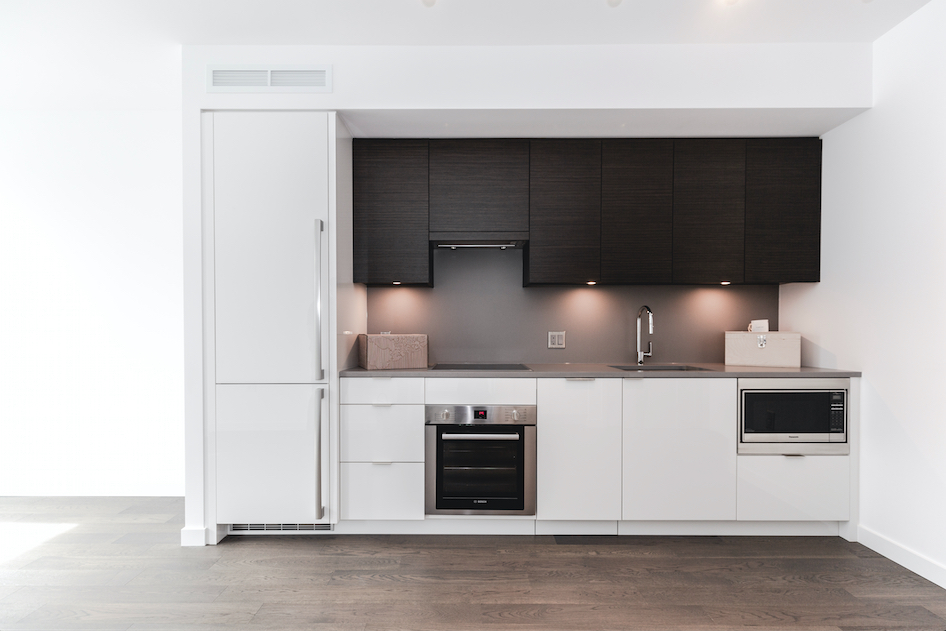 white minimalist kitchen in Olympic Village condo