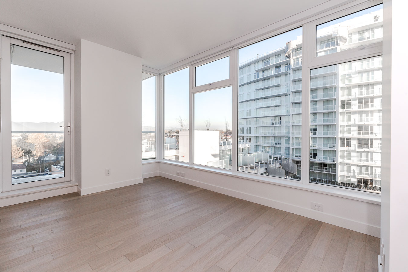 Bedroom with ash flooring at Vancouver condo rental with a view.