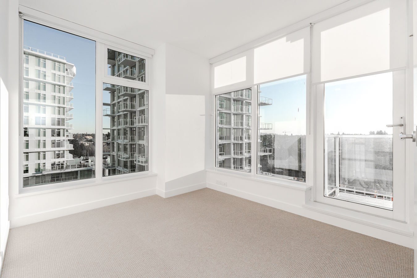 windows in condo room looking out at bright skies