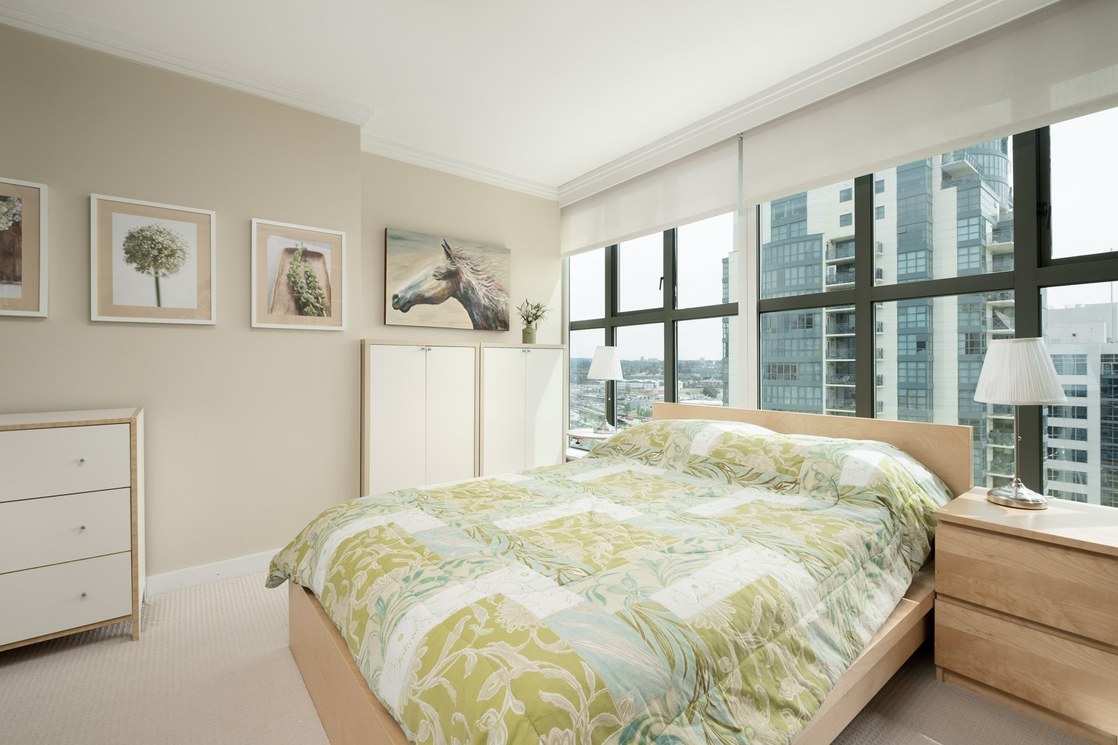 Bedroom inside furnished Downtown Vancouver rental condo with windows offering city views.