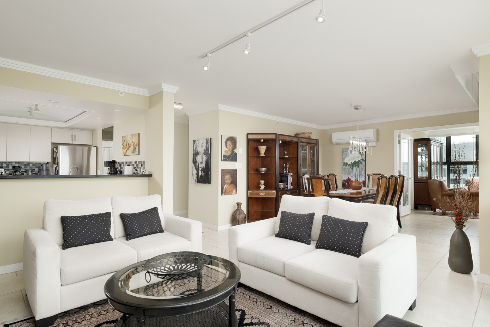 Living area of Vancouver rental with white couches and access to private balcony.