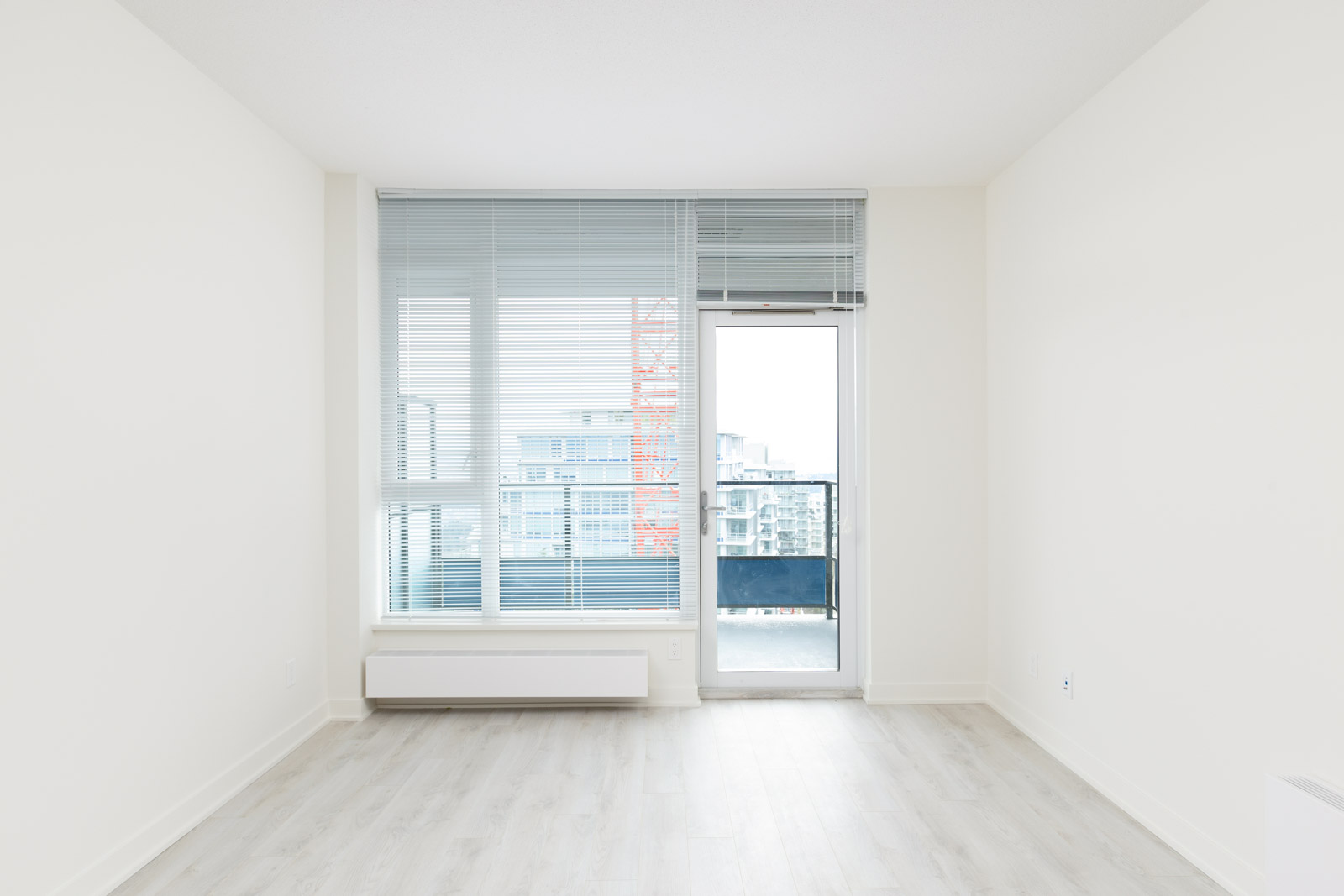 Bedroom with access to balcony at Burnaby Mountain condo rental.