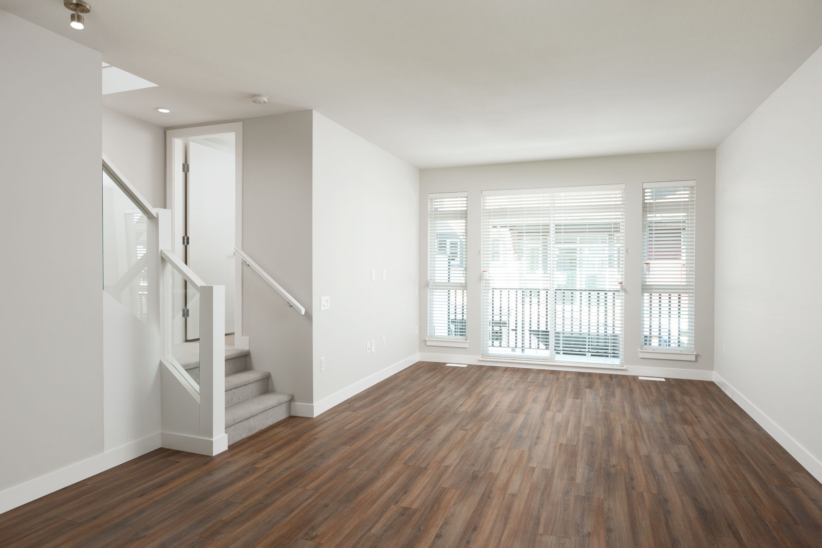 Living area with access to private balcony in Richmond rental townhome.