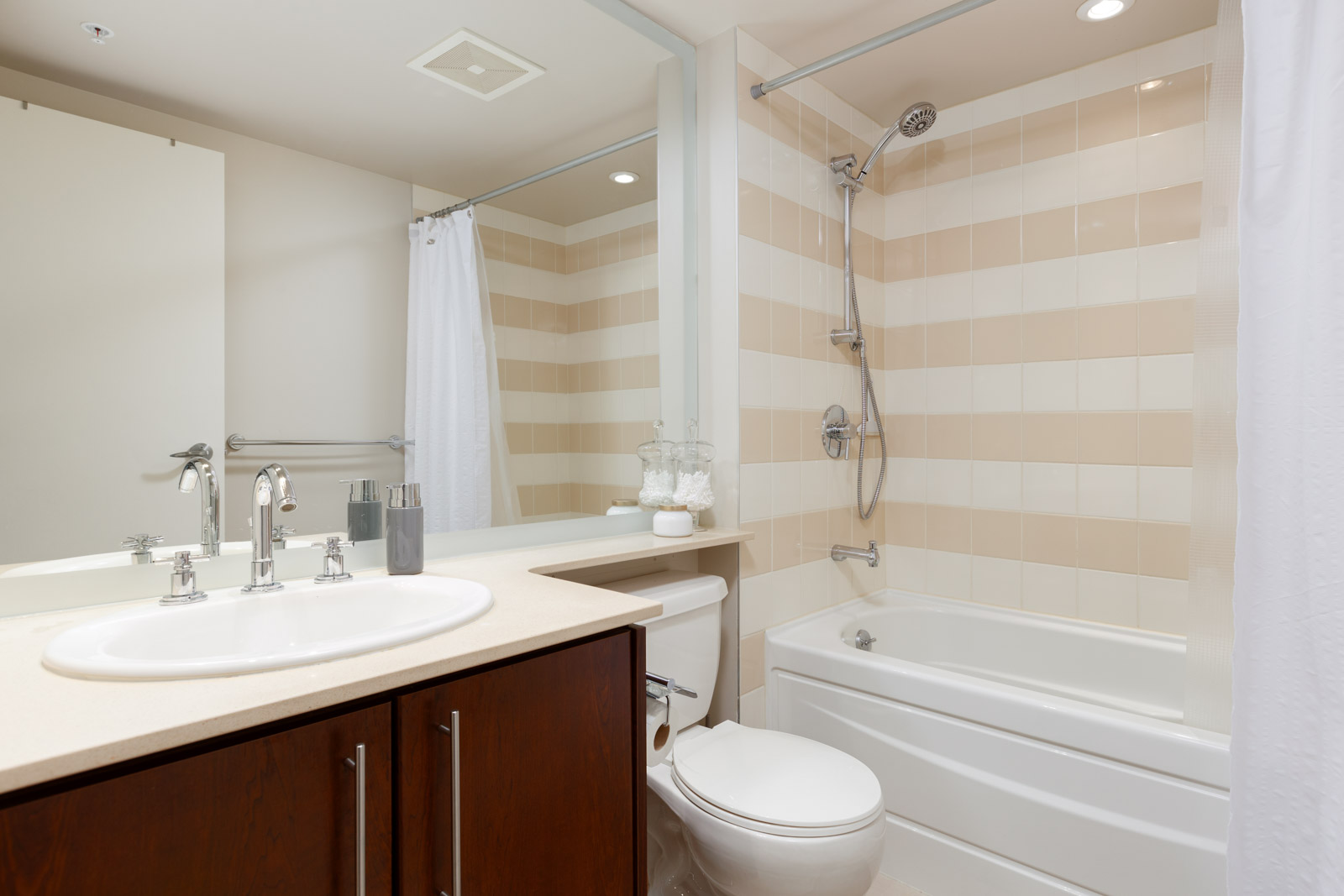 Bathroom with striped tiling in Yaletown Vancouver rental condo.