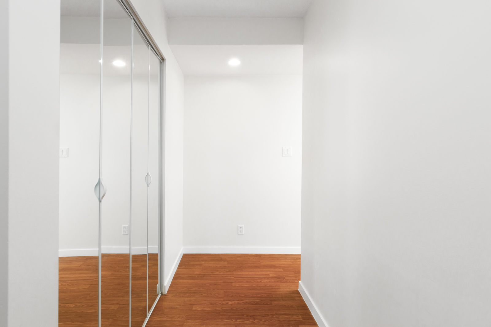 Interior hall with mirrored sliding closet inside Downtown Vancouver rental condo.