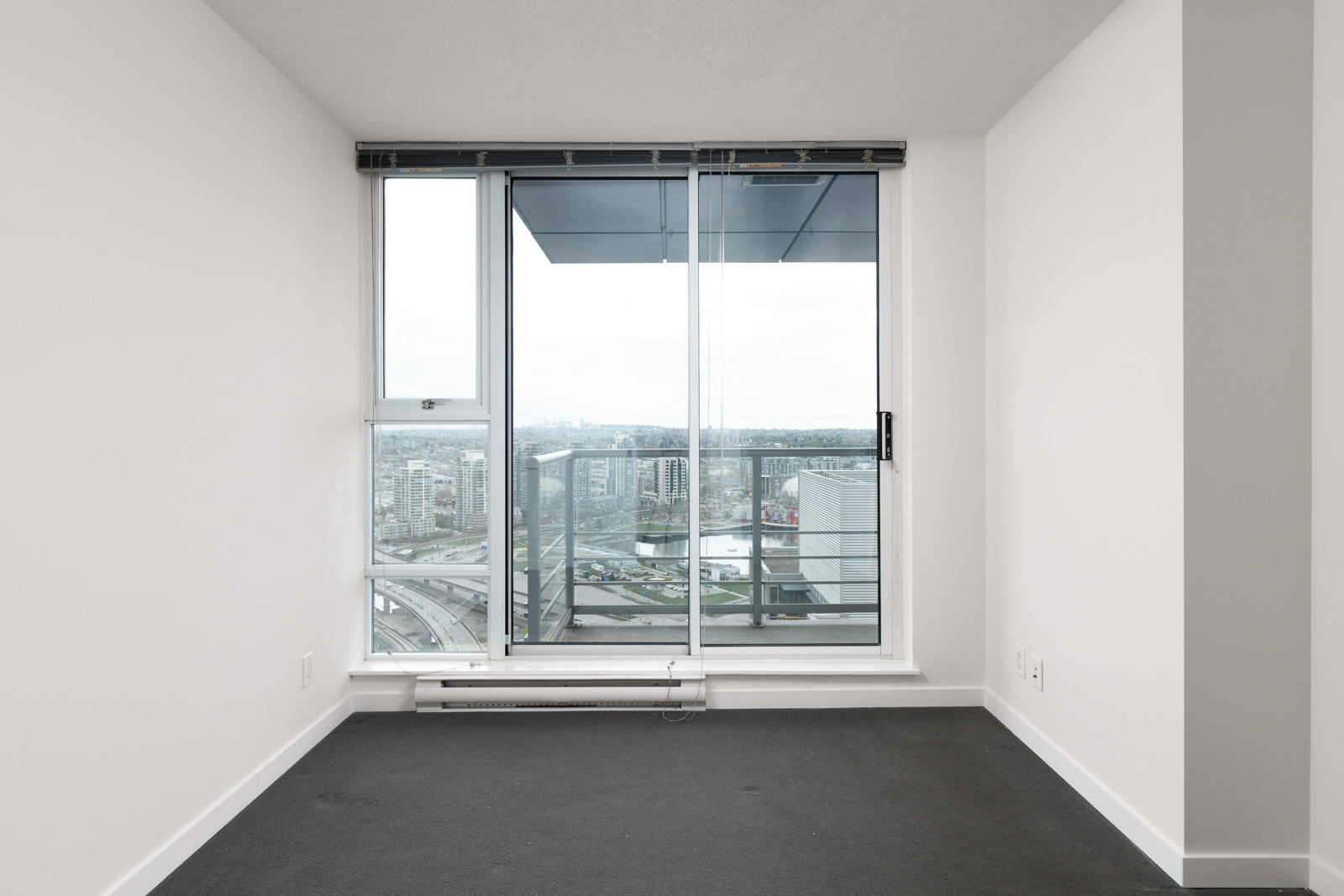 Bedroom with access to private balcony of Downtown Vancouver rental condo.