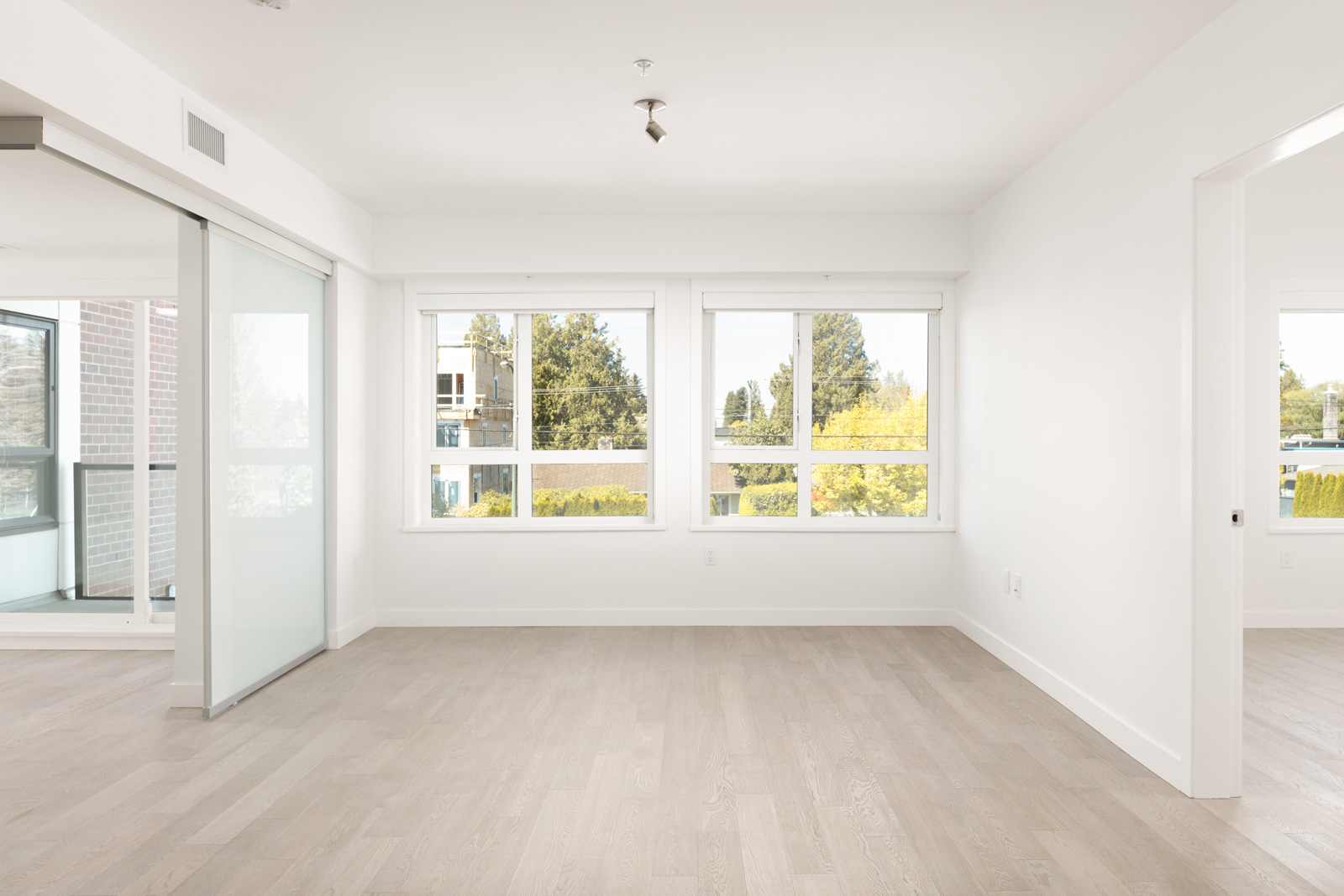 Bedroom with ash hardwood floors inside Vancouver rental townhome with views.