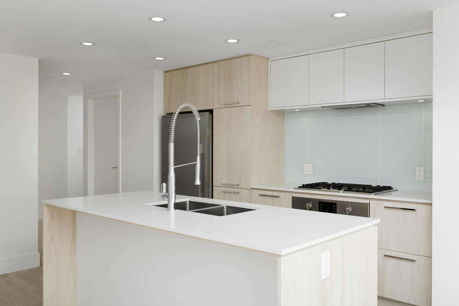 Newly renovated kitchen with stainless steel appliances in North Vancouver condo.
