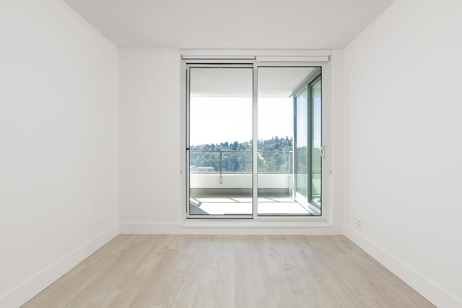 Bedroom with access to private balcony of North Vancouver luxury rental home.