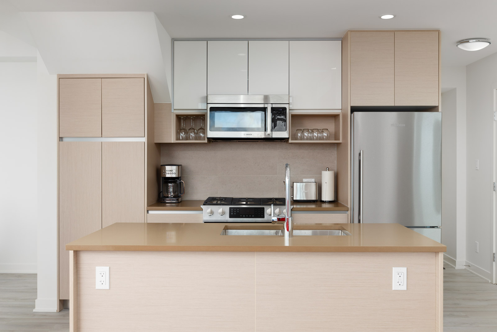Kitchen with stainless steel appliances inside luxury Burnaby Mountain rental penthouse.