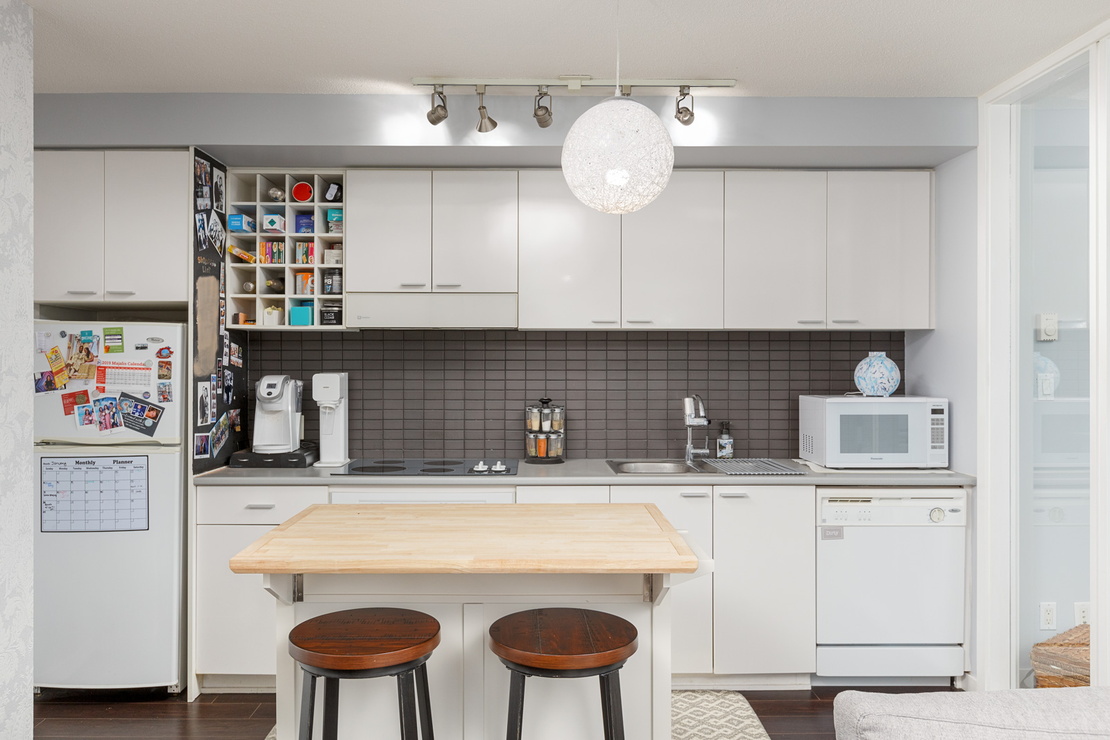 Kitchen in Downtown Vancouver rental condo with island and accompanying bar stools.