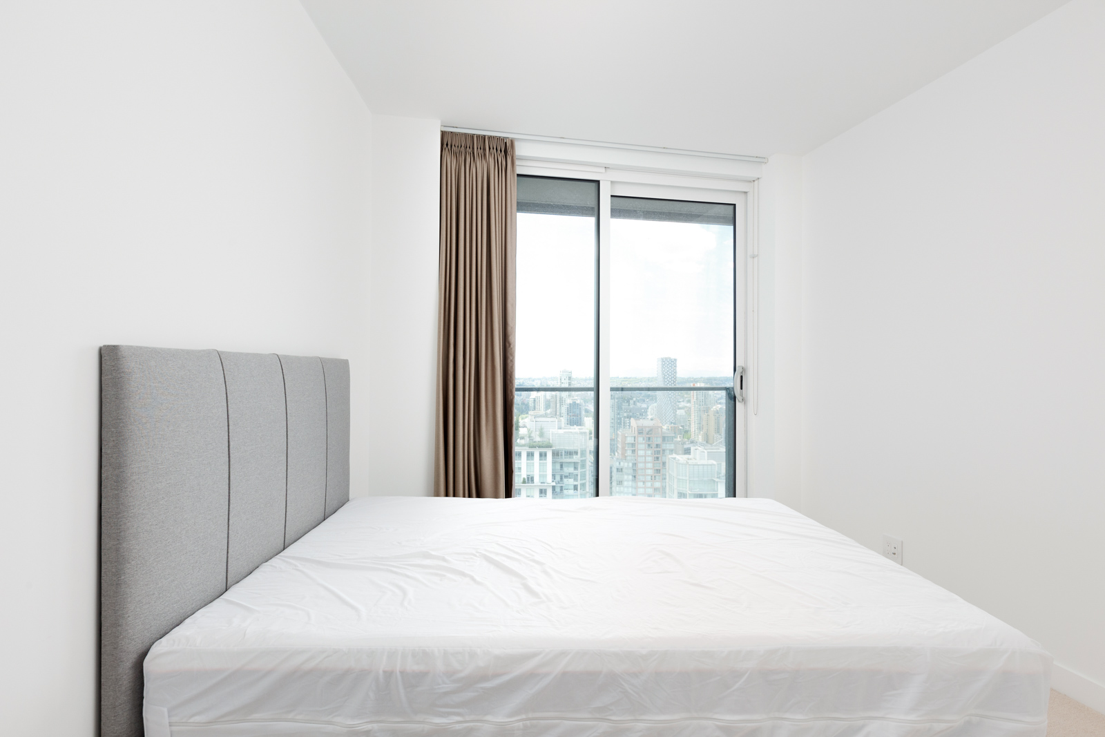 Bedroom in Downtown Vancouver condo with view.