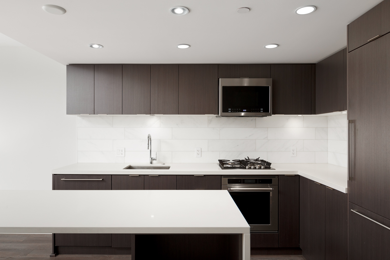 Kitchen with stainless steel appliances inside luxury Downtown Vancouver condo.