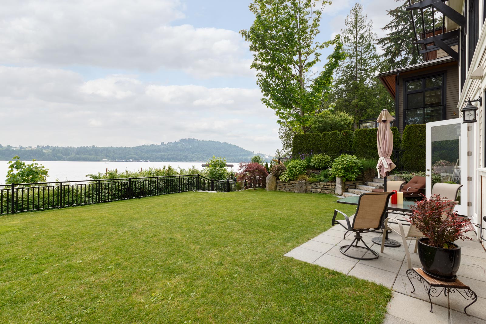 Yard outside North Vancouver luxury rental with view of the water.