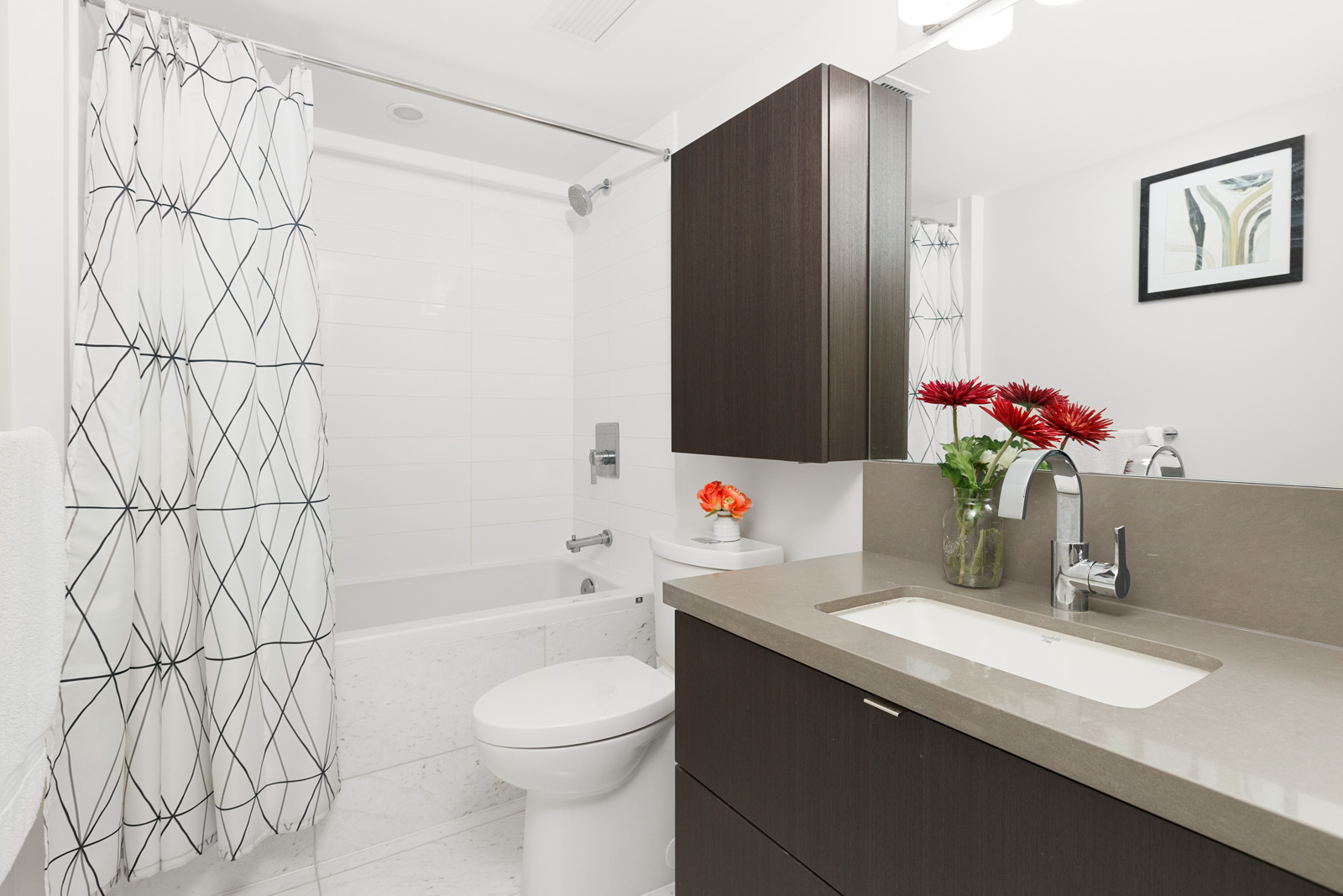 Bathroom with dark wood cabinetry inside luxury Vancouver rental.