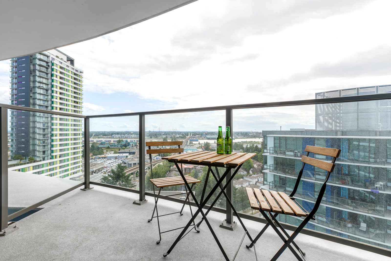 Private balcony with views of Vancouver city skyline from luxury furnished rental.
