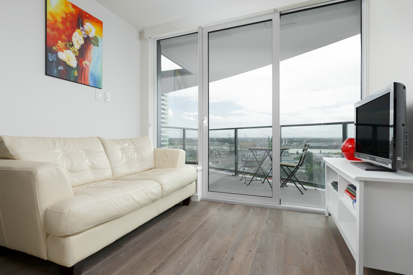Living room inside luxury Vancouver condo with access to private balcony.