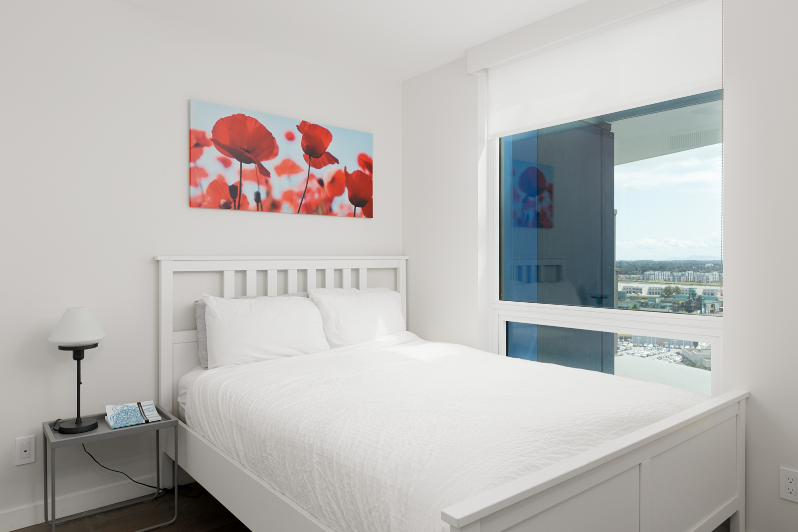 Bedroom inside luxury rental condo with views of Vancouver.