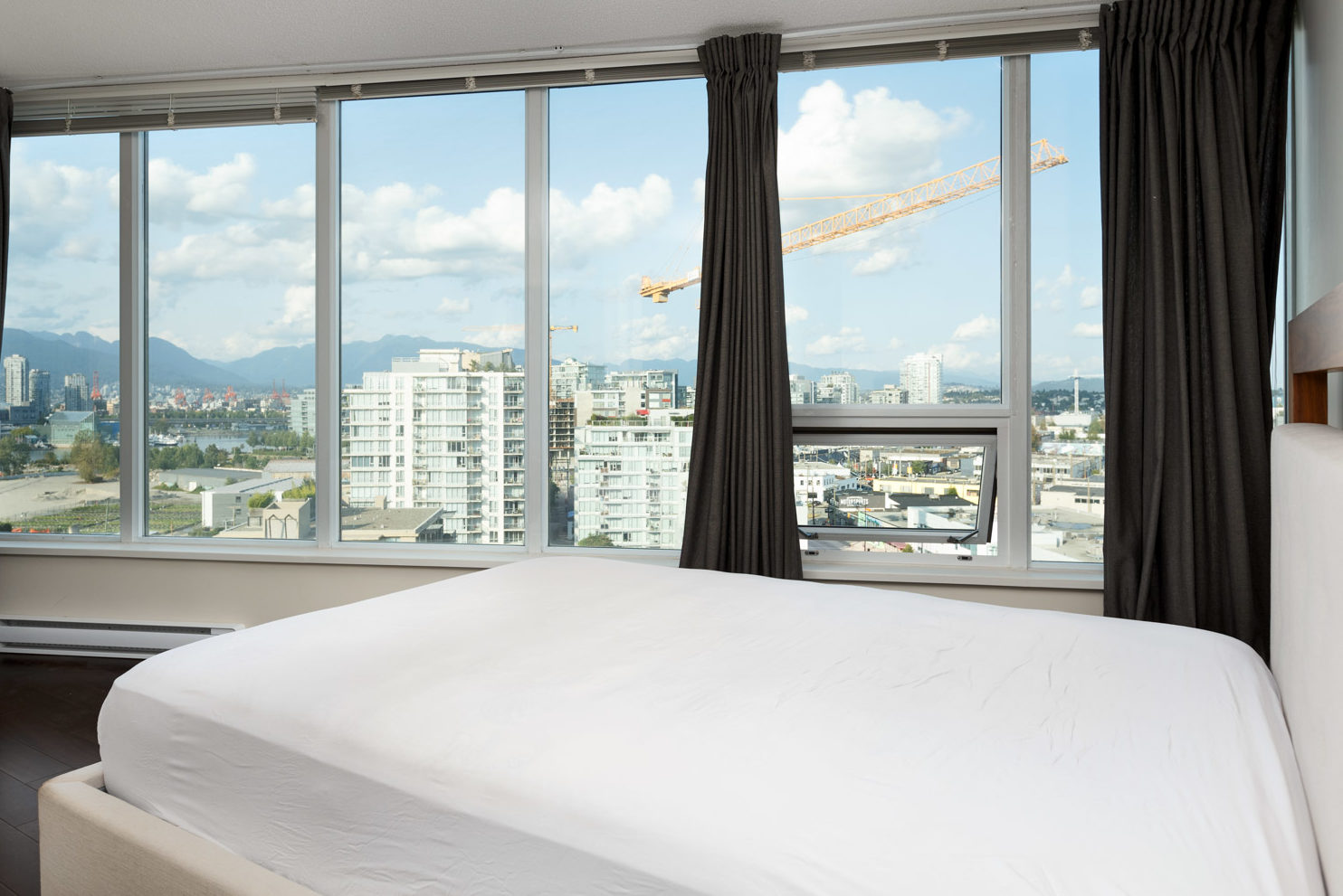 Bedroom in Vancouver rental condo with views of the city.