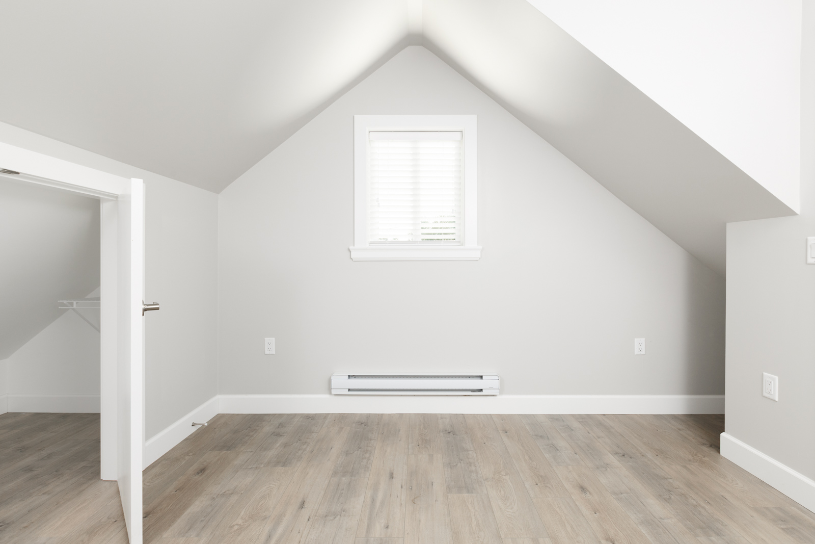 Uppermost floor of Vancouver unfurnished rental with sloped ceiling.