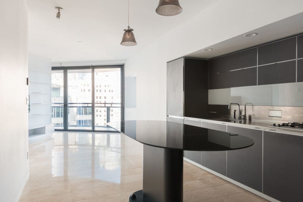 Oval, black kitchen island in luxury Downtown Vancouver rental.