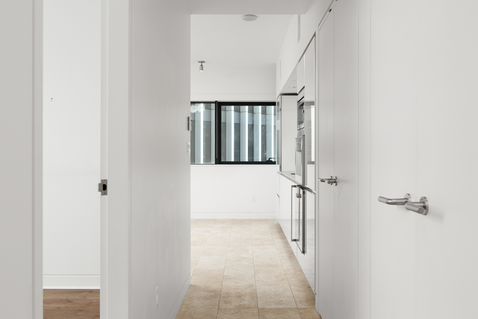 Hallway in Jameson House condo in downtown Vancouver with travertine stone flooring