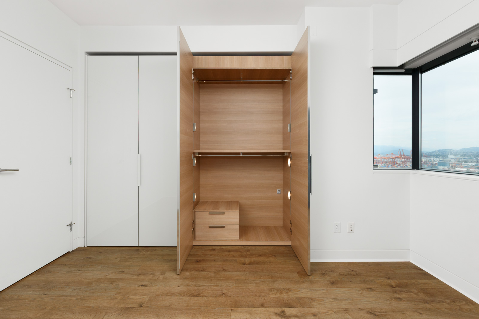 Closet with open doors in bedroom of Jameson House condo in downtown Vancouver