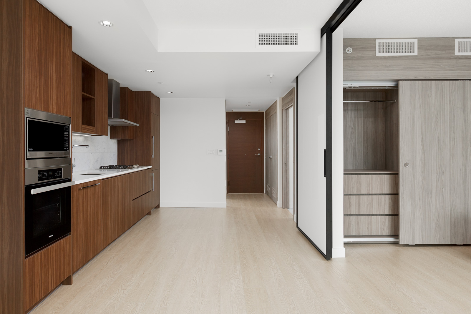 living room with kitchen and wood cabinets on left in arc rental condo