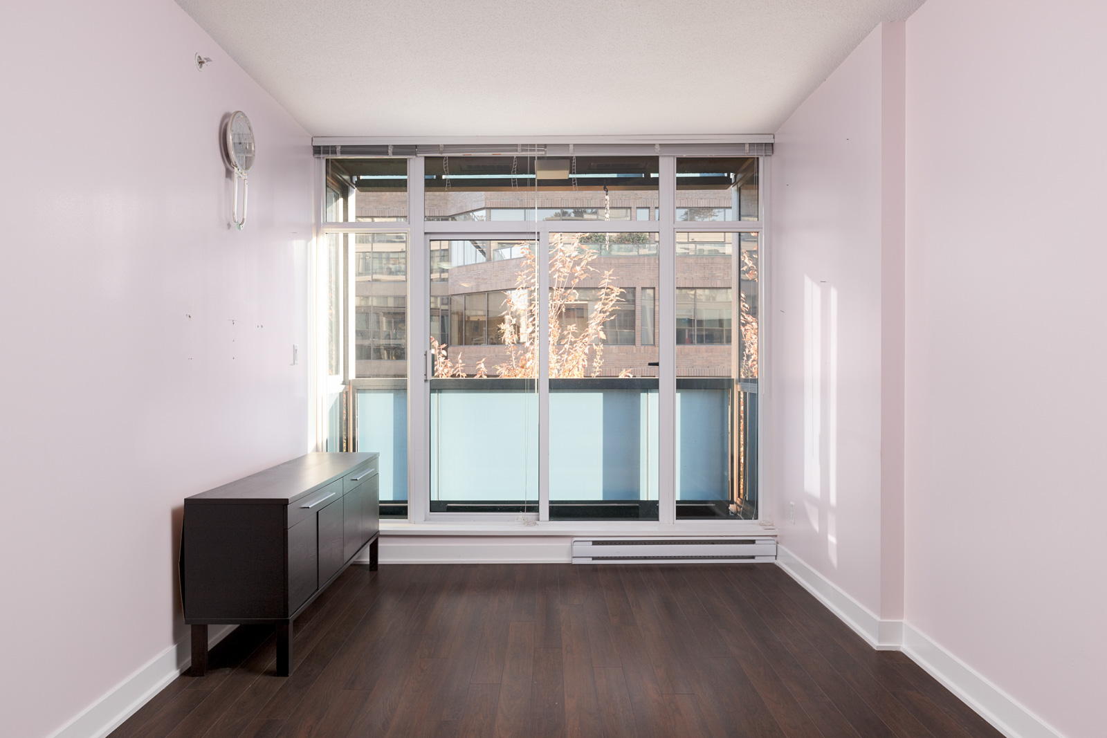Living room with windows and dark hardwood floors in Kits360 condo rental