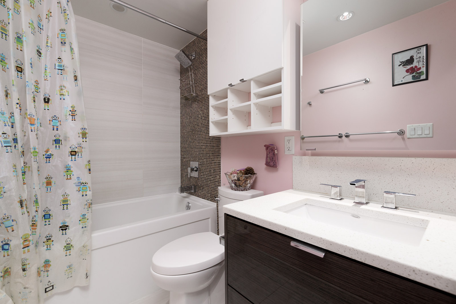 Bathroom with toilet, bath, tiled walls, and vanity and mirror with dark cabinet doors