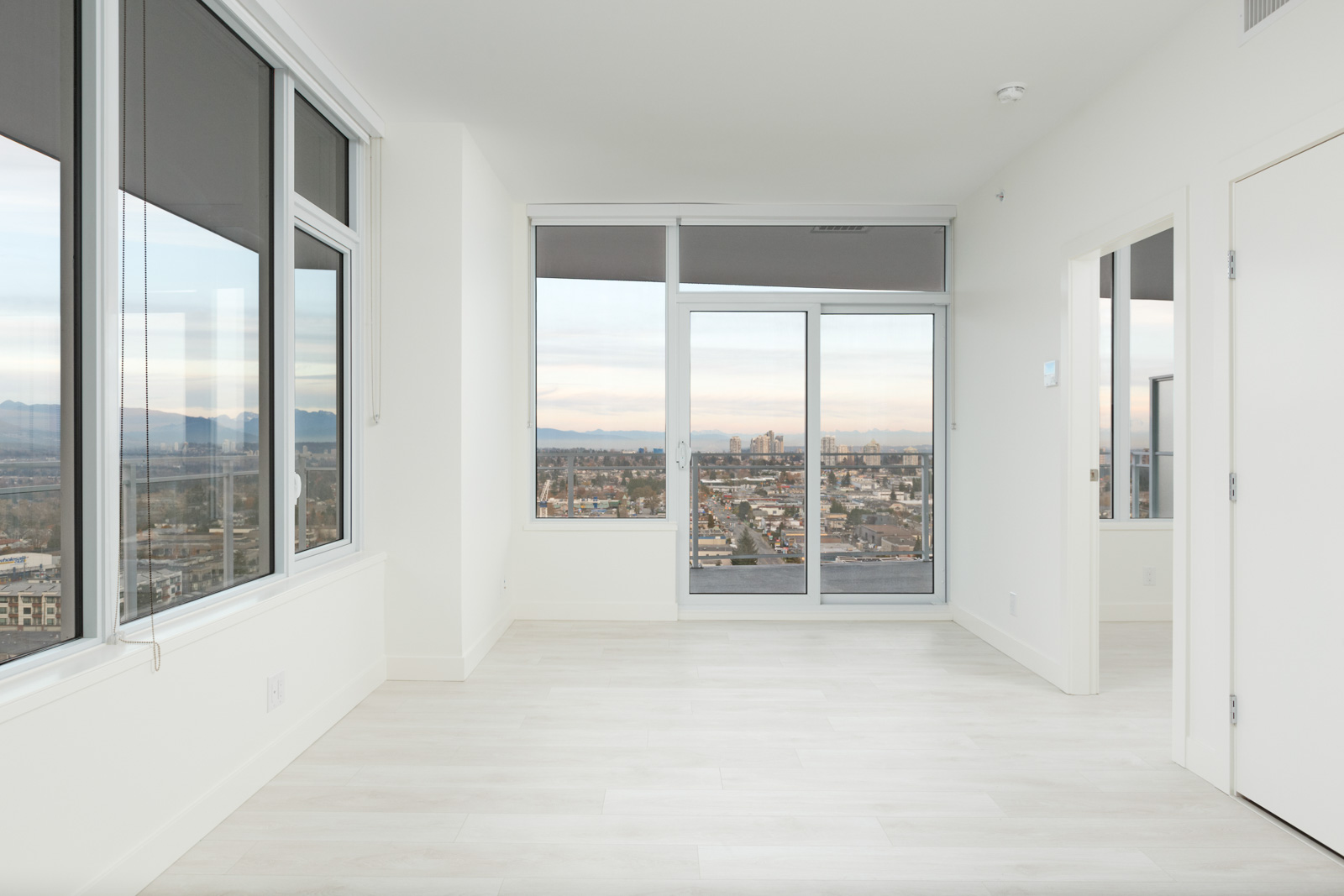 living room with windows and door to balcony in metrotown burnaby condo for rent