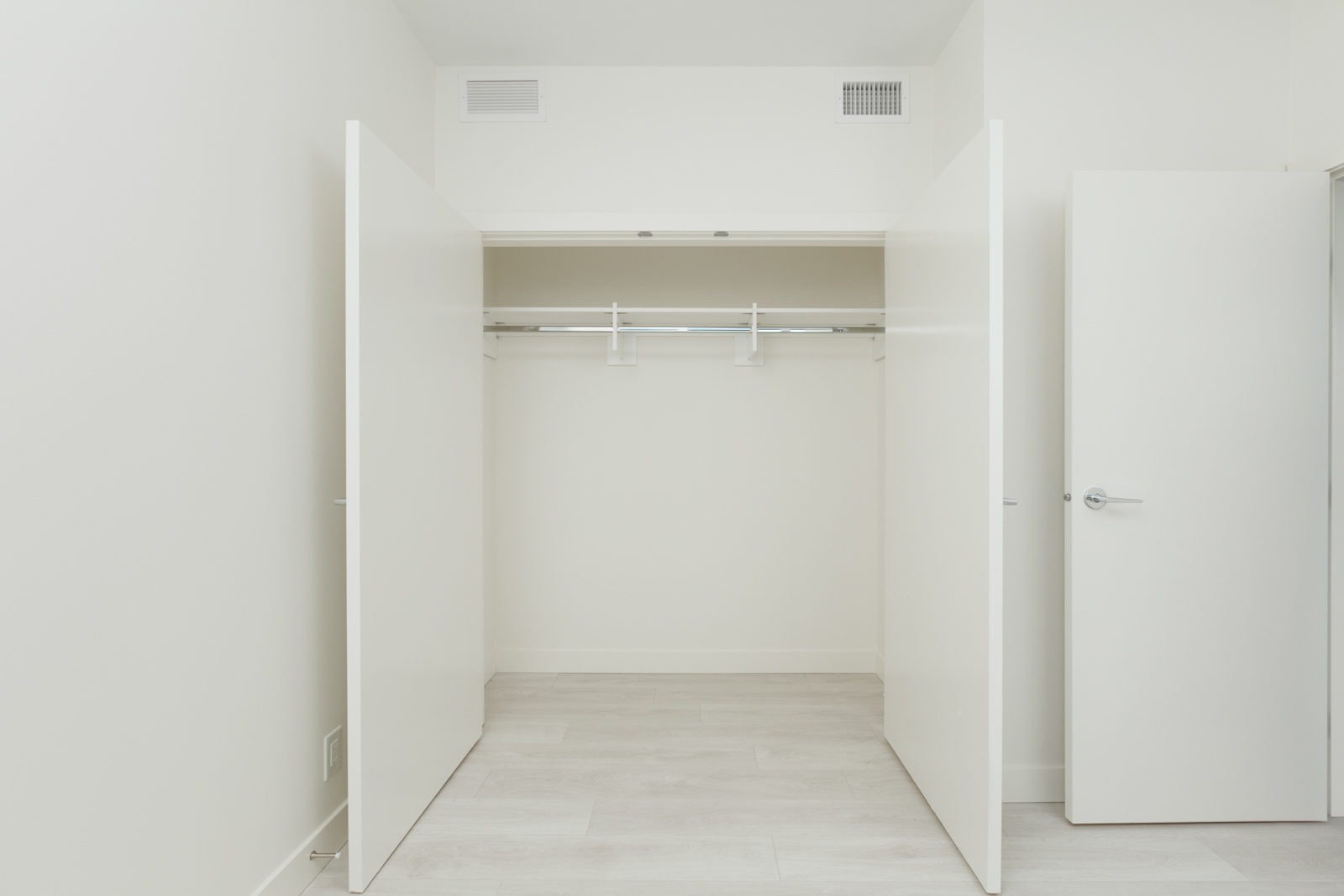 closet with two open doors in bedroom of burnaby condo