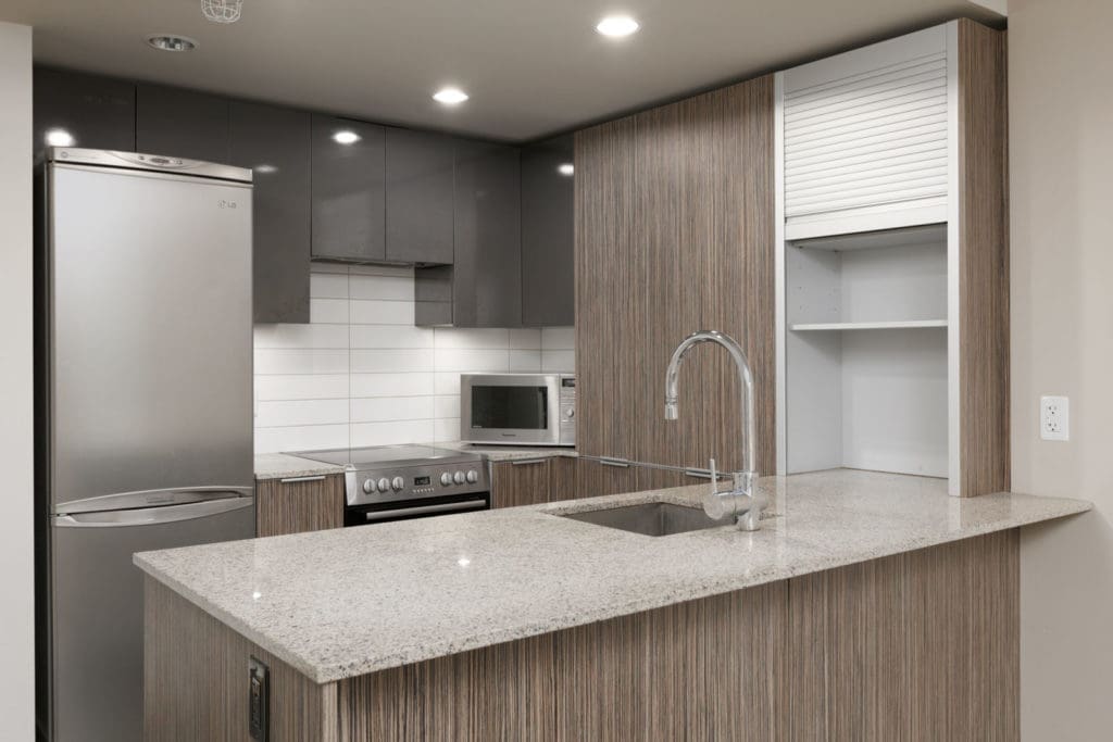 kitchen in yaletown condo with stainless steel appliances in yaletown vancouver