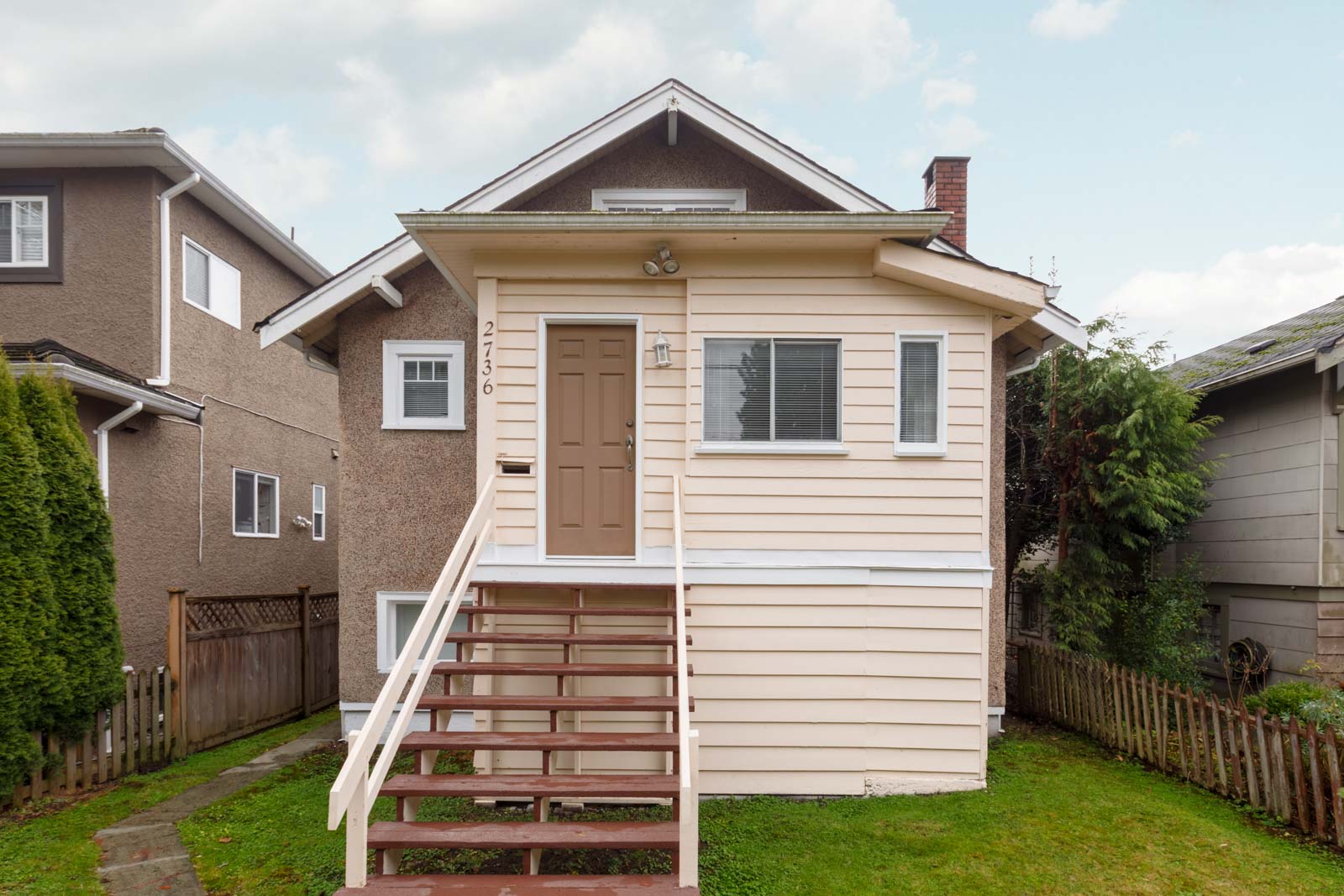 back of kerrisdale vancouver house with yellow siding and for rent and managed by birds nest properties
