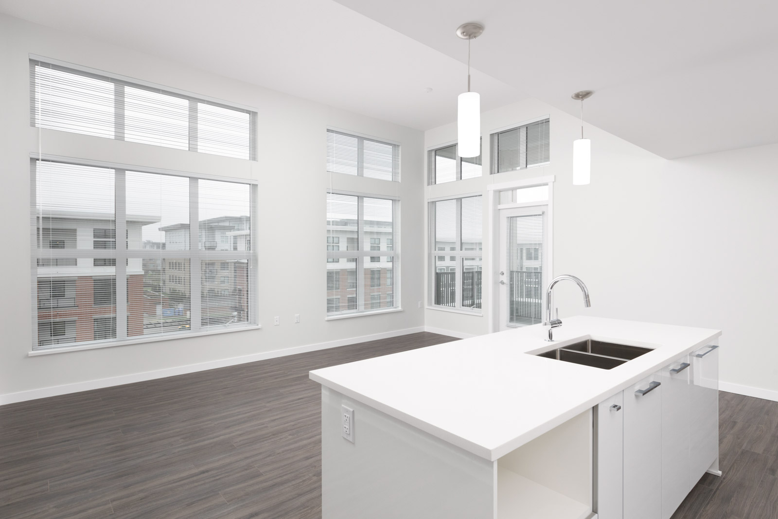 white kitchen counter in living room of rental townhouse in richmond with windows
