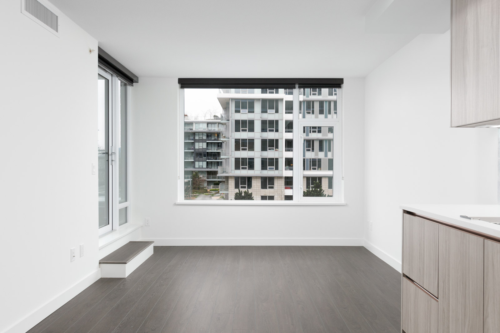 view of building outside from window of new empty living room in concord gardens south estate on hazelbridge in richmond