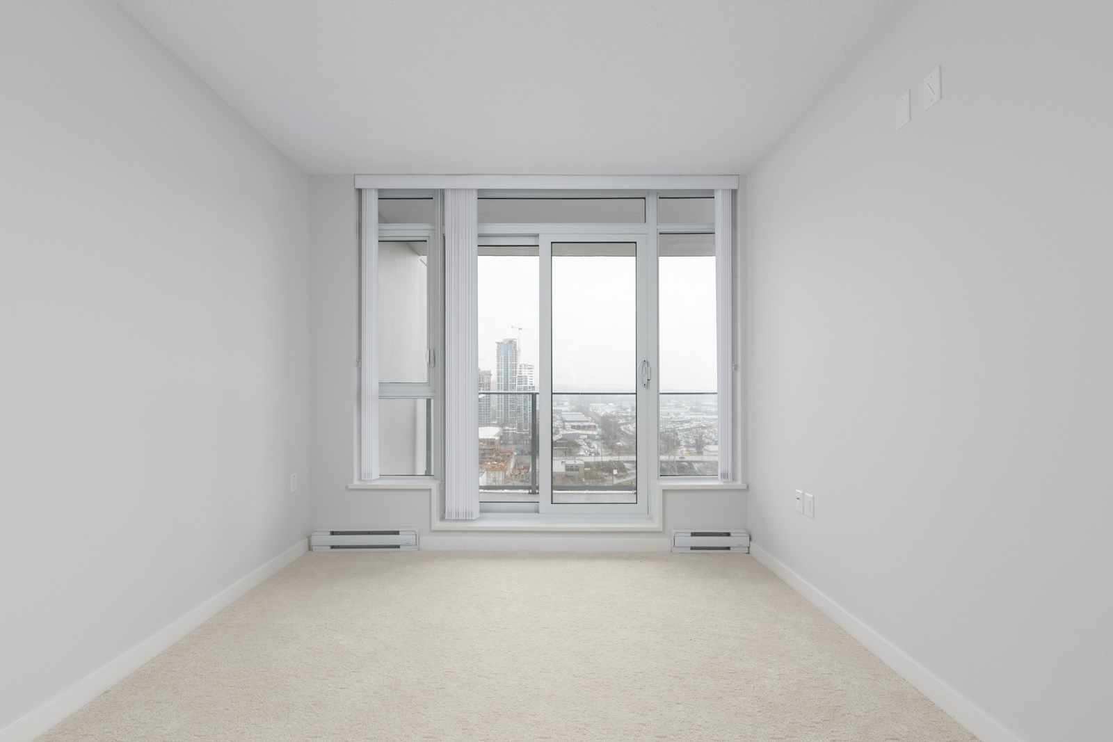 living room with floor to ceiling windows empty new rental condo at fulton house on madison in brentwood neighbourhood of burnaby