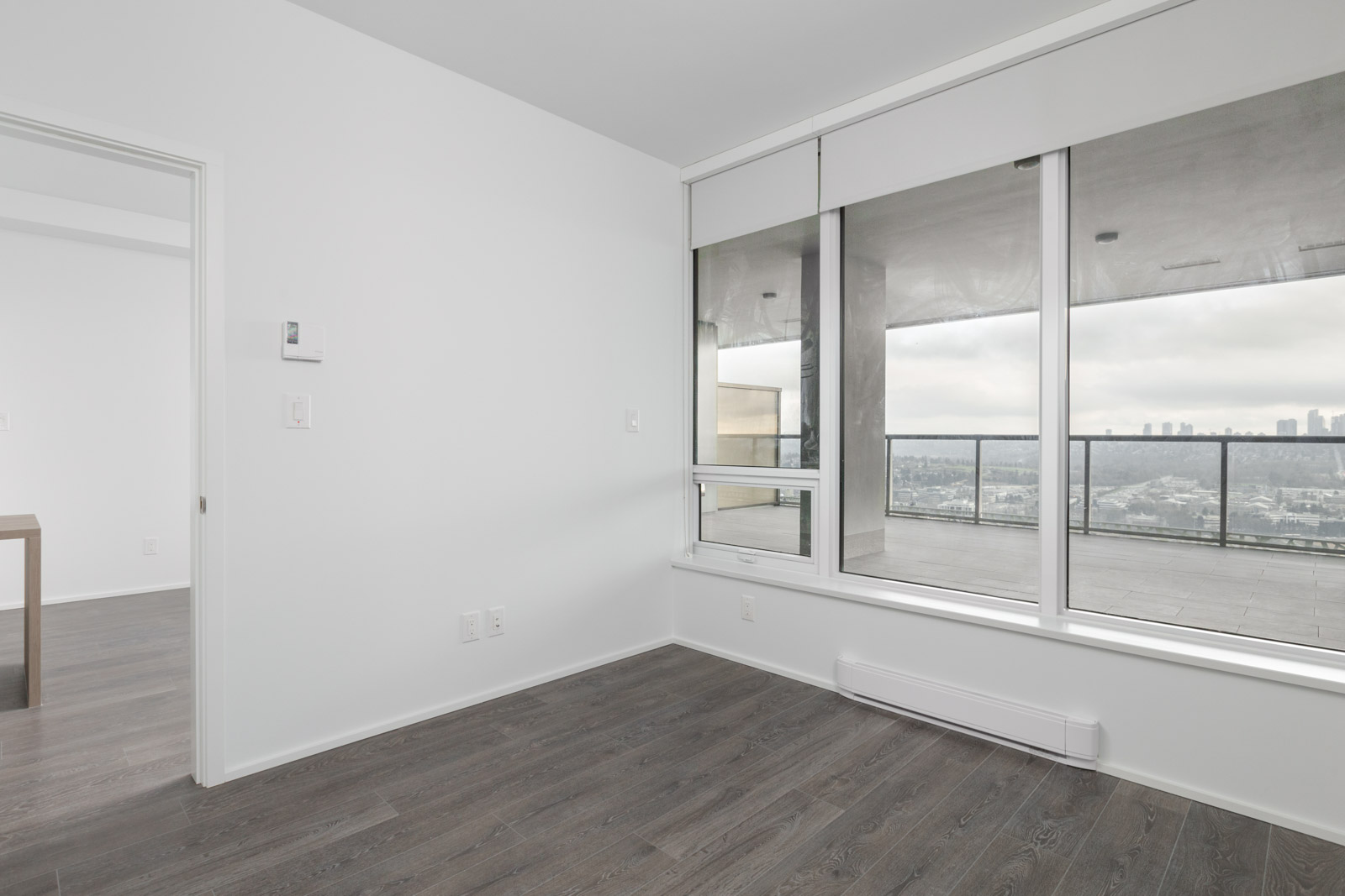 diagonal view of bedroom with windows on right in brand new condo at brentwood tower one of amazing brentwood in burnaby
