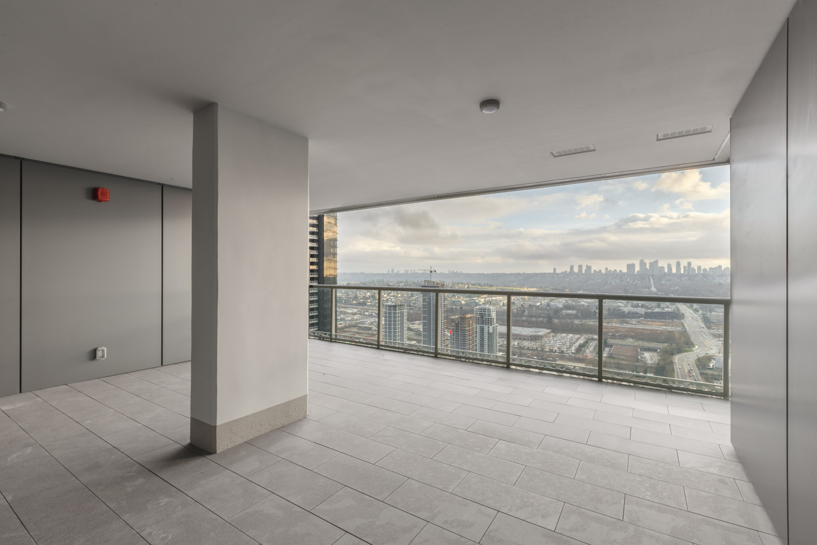 large balcony of brand new condo at brentwood tower one of amazing brentwood in burnaby with concrete pillar in middle