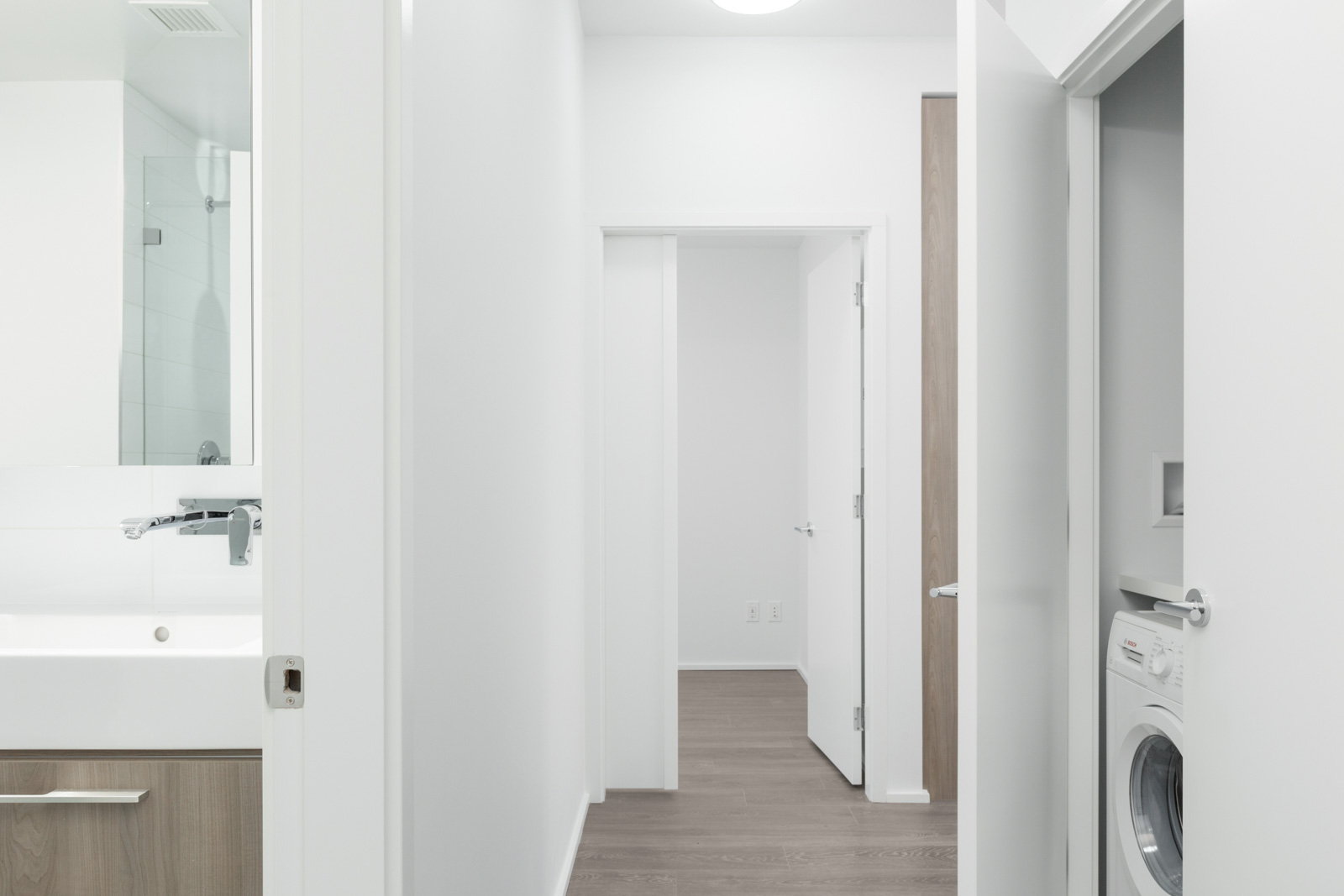 corridor with open doors on both sides and at the end in brentwood tower one condo building