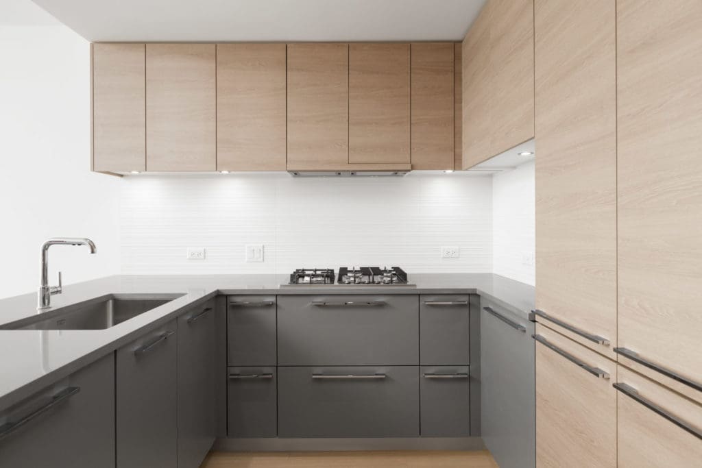 kitchen wall with stovetop in empty brand new condo managed by birds nest properties at kings crossing in burnaby