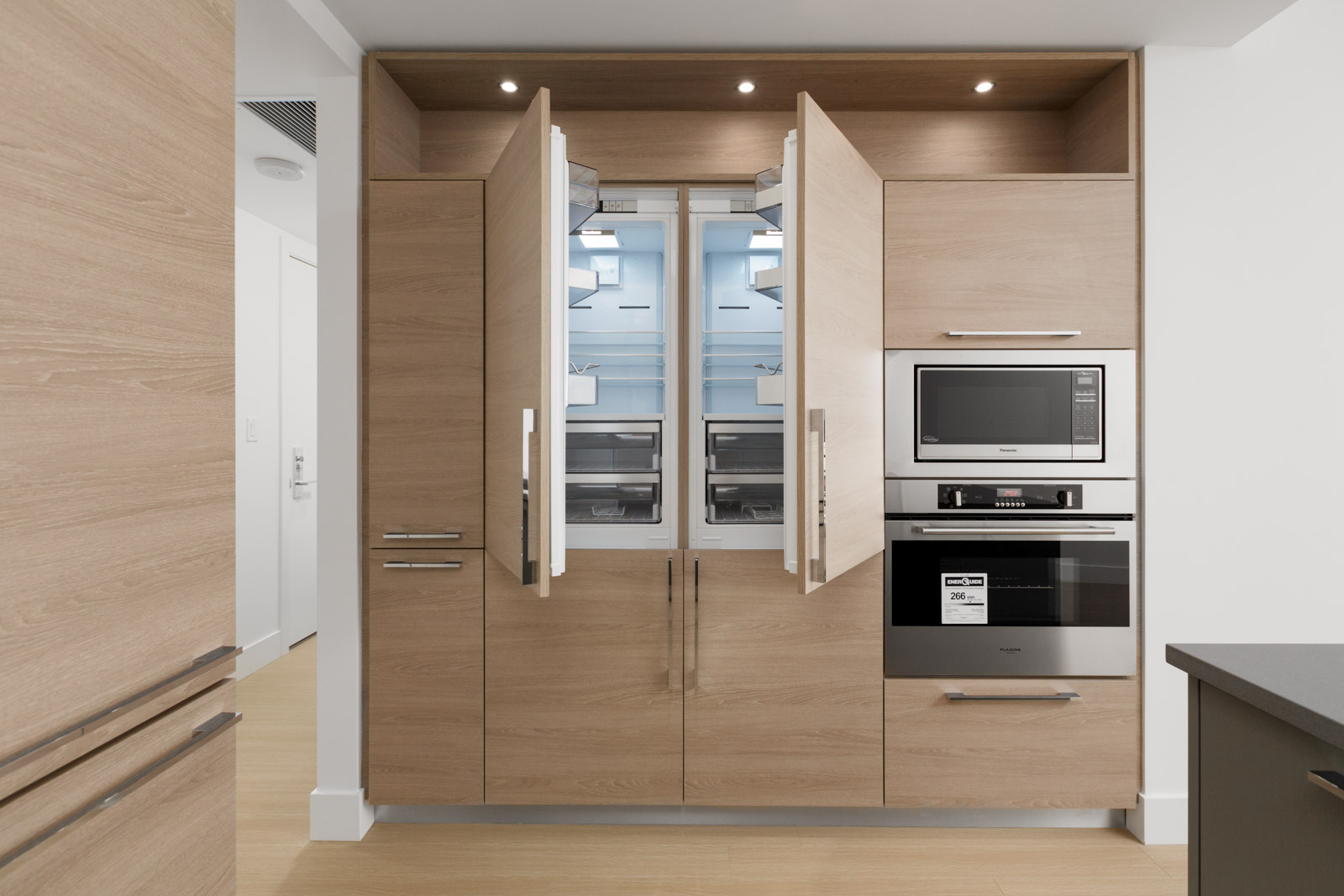 open refrigerator doors in empty brand new condo managed by birds nest properties at kings crossing in burnaby