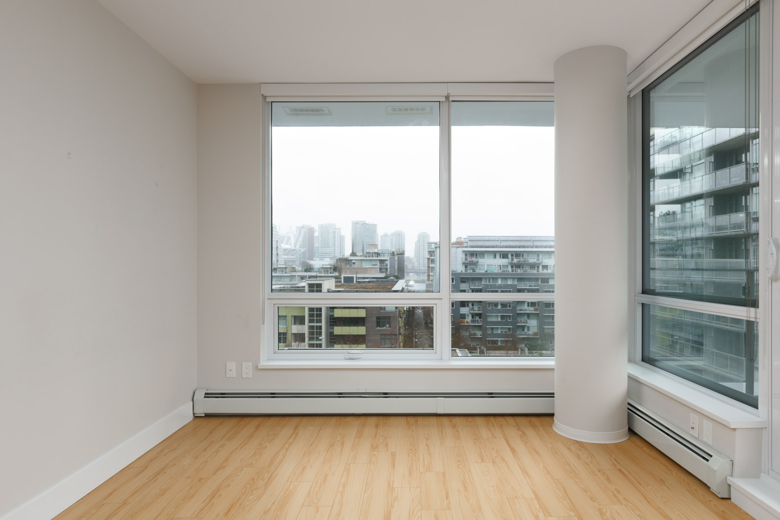empty living room of rental condo at tower green in false creek olympic village vancouver managed by birds nest properties