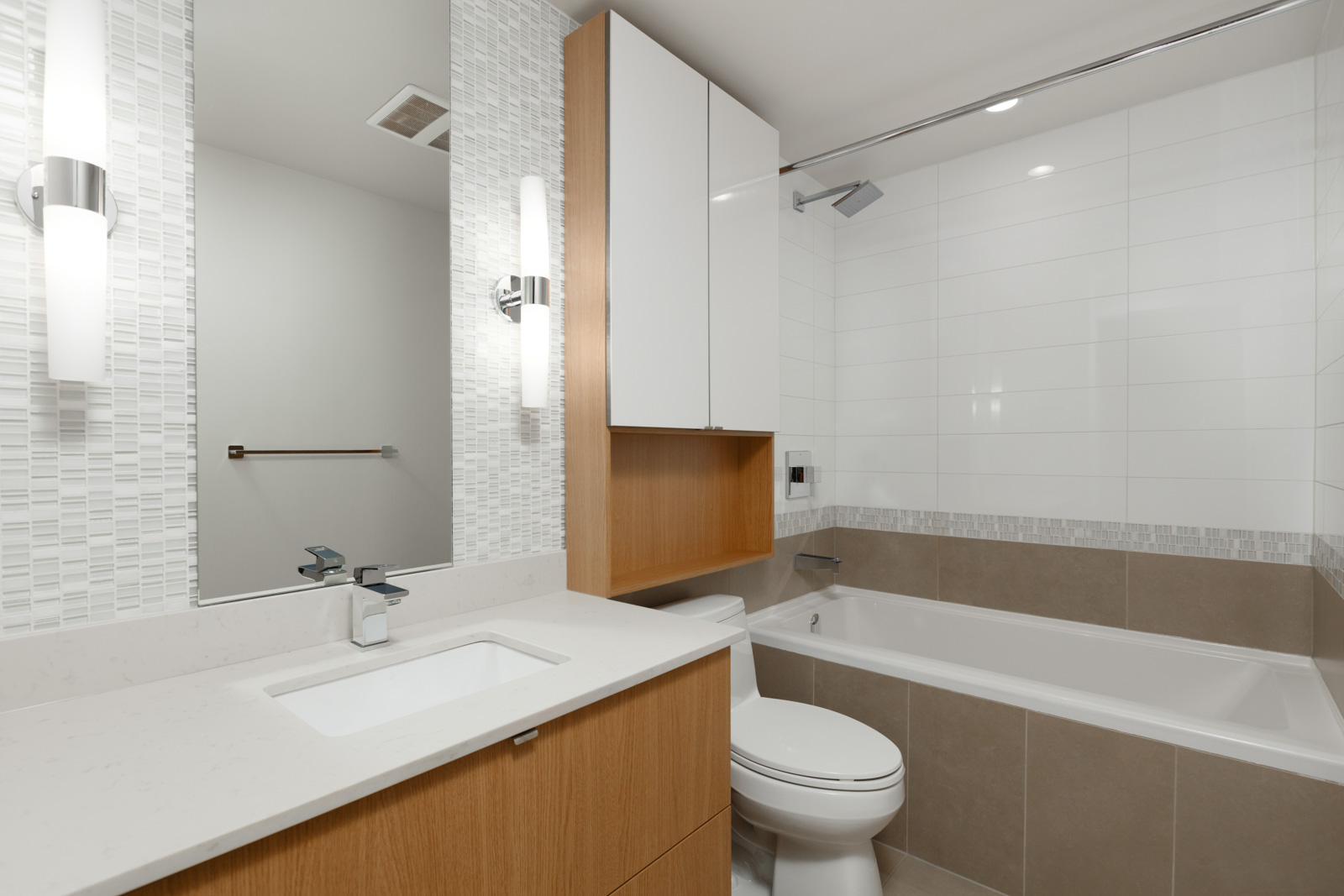 bathroom with sink mirror toilet and tub of rental condo at tower green in false creek olympic village vancouver managed by birds nest properties
