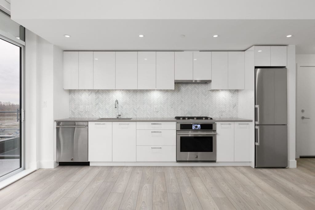 kitchen of empty condo managed by birds nest properties at avalon 2 at 8570 rivergrass drive in river district vancouver