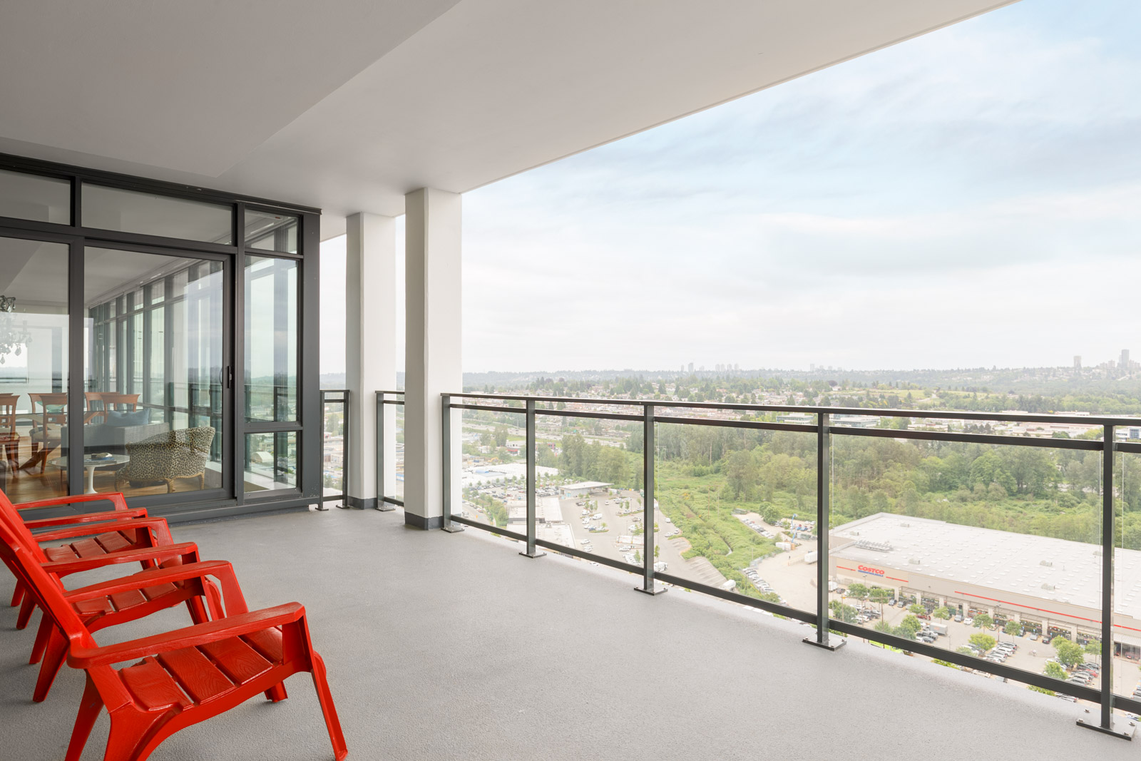 Grand view of Burnaby from the balcony with entertainment and seating space in a rental condo in Burnaby offered by Birds Nest Properties.