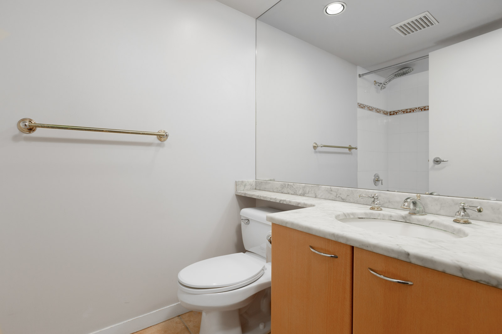 bathroom with white walls and big mirror