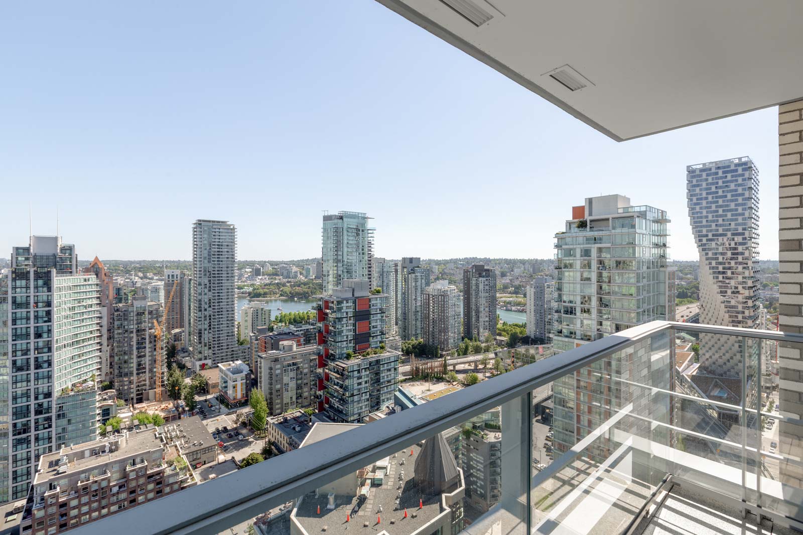 balcony with view of clear skies in rental condo in the Yaletown neighbourhood of Vancouver