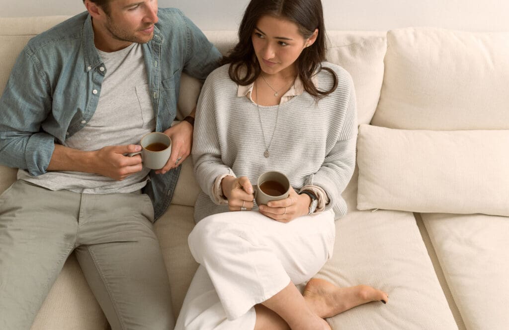 couple sit on couch in stylish Vancouver condo