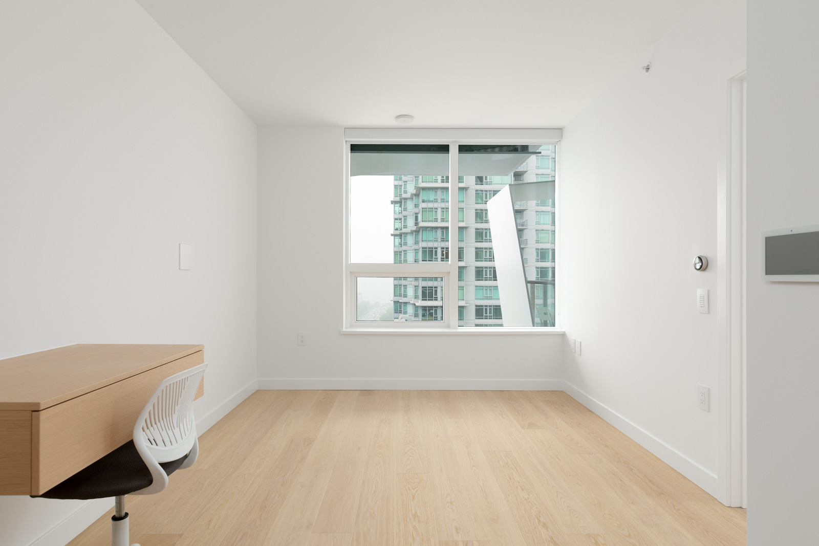 empty living room in bosa brand new cardero building designed by henriquez partners architects in coal harbour in downtown vancouver